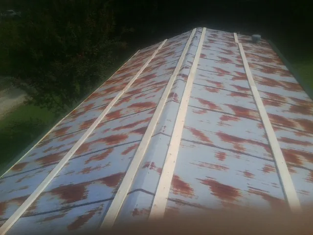 Rusted metal roof panels with new wood purlins before replacement — Storm Damage Roof Repair in Healdton by Roofing Brothers