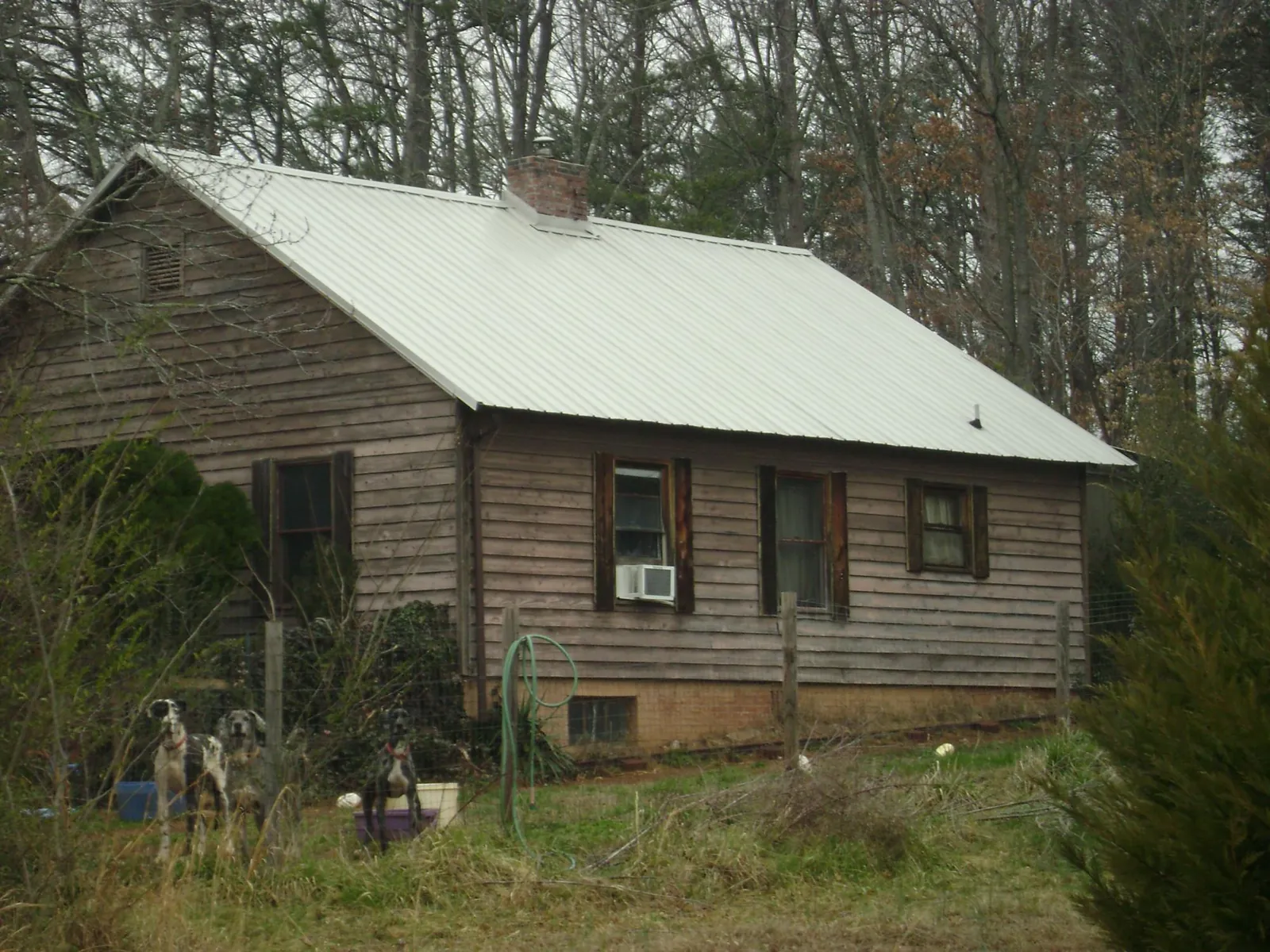 White metal roof on an old wood sided farmhouse, from a Metal Roof Installation job in Healdton